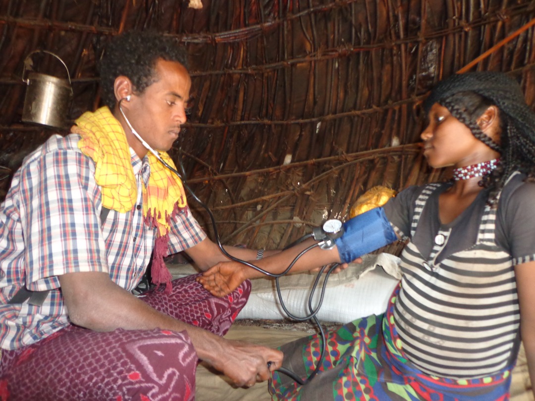 APDA health worker checking woman in rural Afar