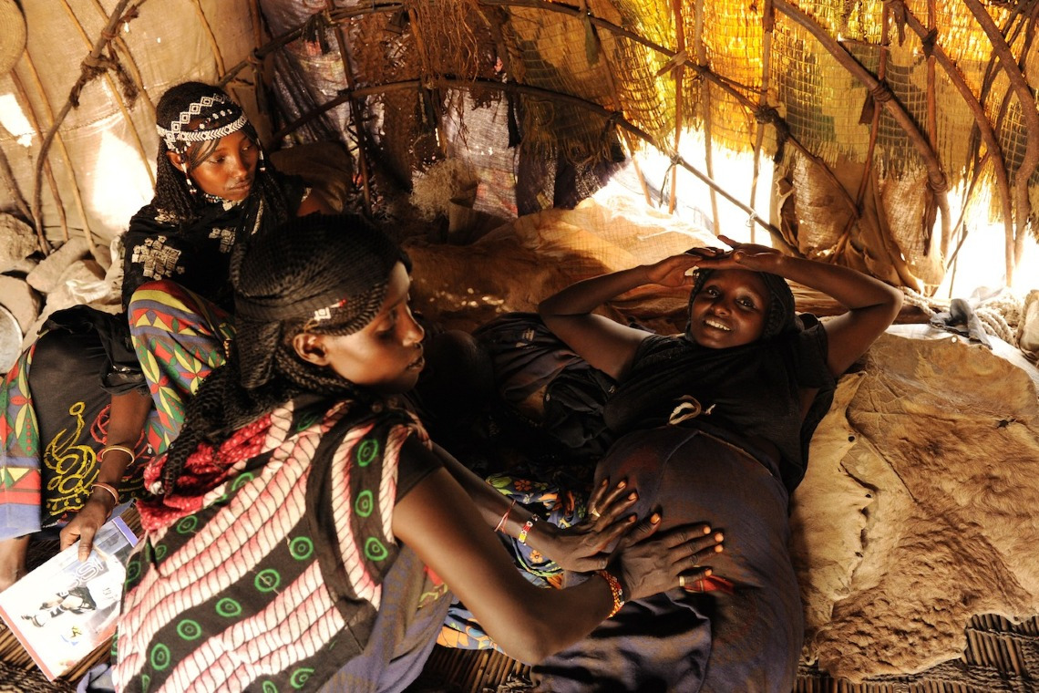 Trained Traditional Birth Attendant providing antenatal care to expectant mother