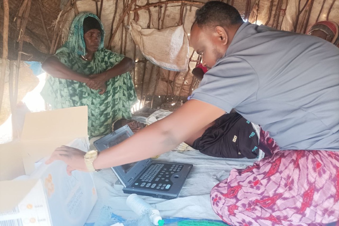 Mobile health worker performing in-house ultrasound